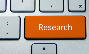 Keyboard close up of orange "Research" button