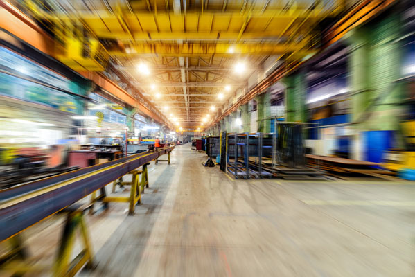 Factory at work, colorful factory looking down line, blurred motion effect