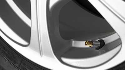 Close up on Vehicle wheel focusing on Schrader valve stem