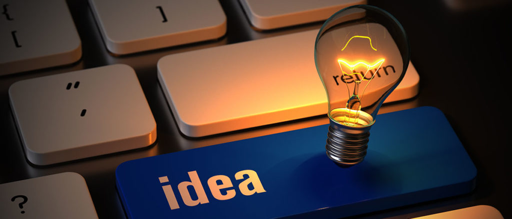 Idea Key on keyboard in blue, with lit lightbulb hovering over it