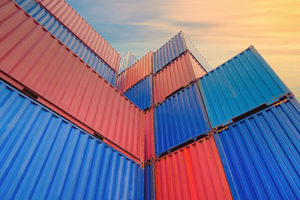 Bright Blue and red shipping container stacked high, view from ground