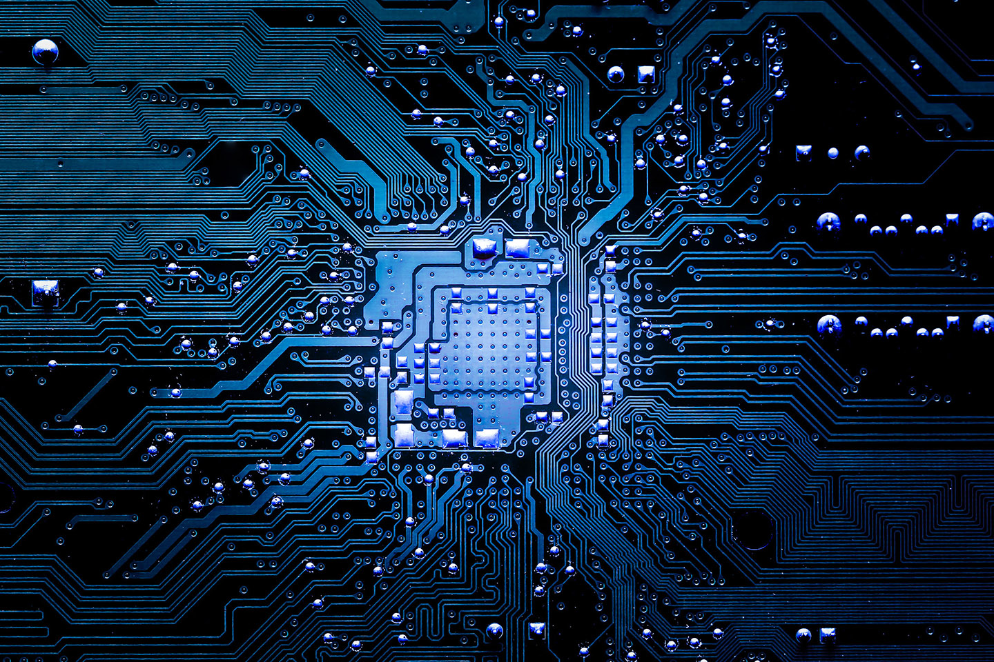 Closeup of electronic circuit board in blue, representing Paper-Less MES Overview Page